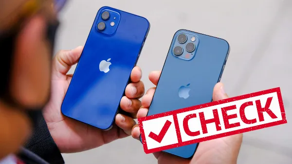 alt: Một người đang kiểm tra ngoại hình của một chiếc iPhone cũ, tập trung vào các góc cạnh và màn hình
