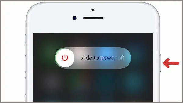 Một chiếc iPhone 7 màu đen với nút Home vật lý, đang hiển thị màn hình "Trượt để tắt nguồn"